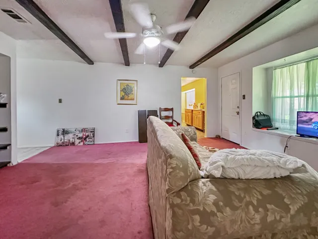 a bed room with a bed furniture and a large window