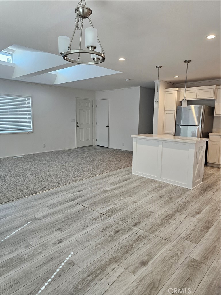 1560 Massachusetts Avenue, Unit 94 Riverside, CA 92507 - Photo 13 of 14 a view of a kitchen with furniture and wooden floor