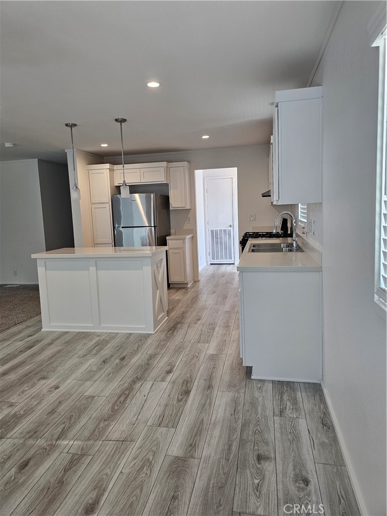 1560 Massachusetts Avenue, Unit 94 Riverside, CA 92507 - Photo 7 of 14 a kitchen with a refrigerator and a stove top oven