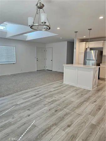 a view of a kitchen with furniture and wooden floor