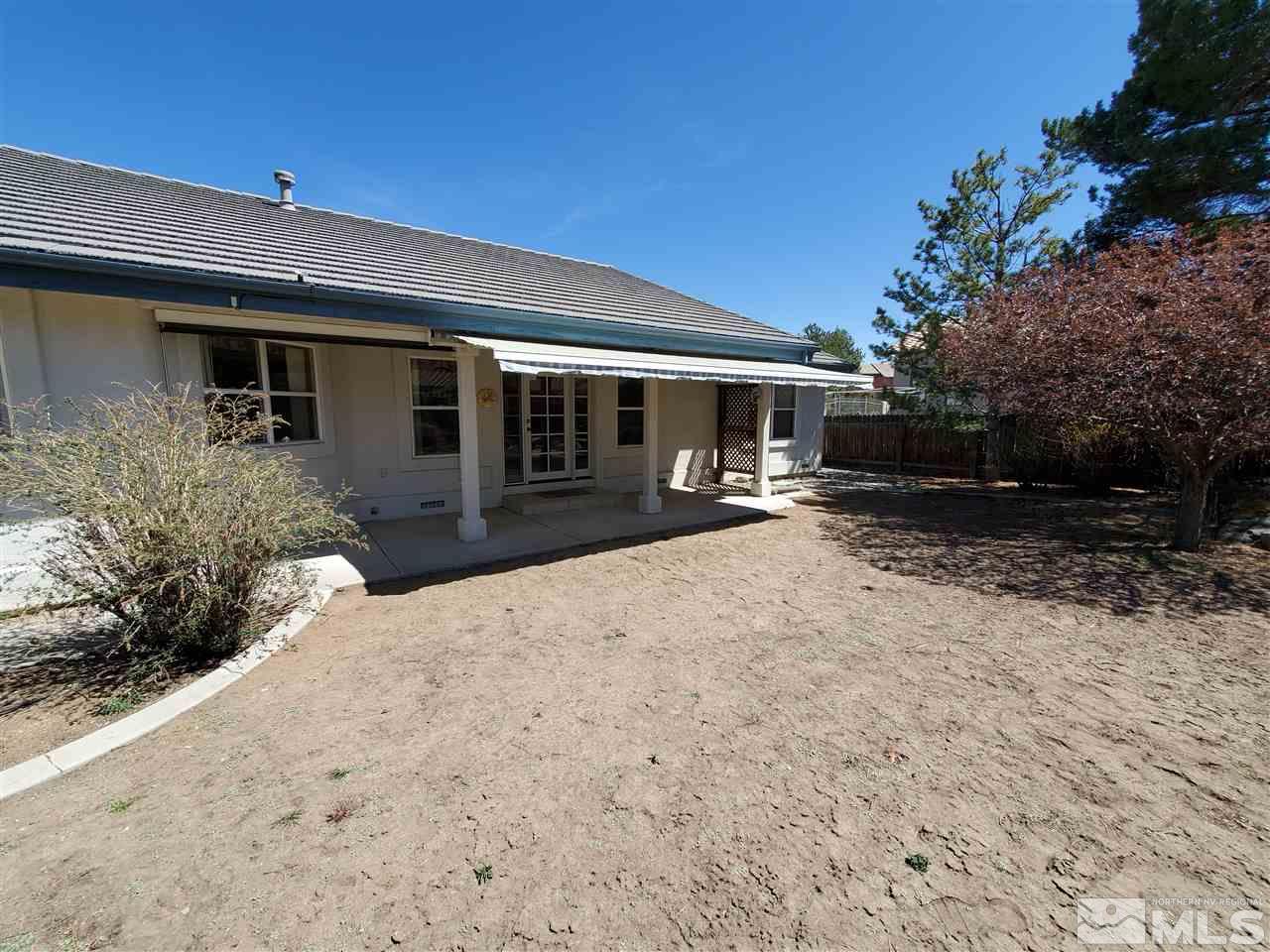 12650 Buckthorn Lane Reno, NV 89511 - Photo 18 of 20 a front view of a house with a yard and garage
