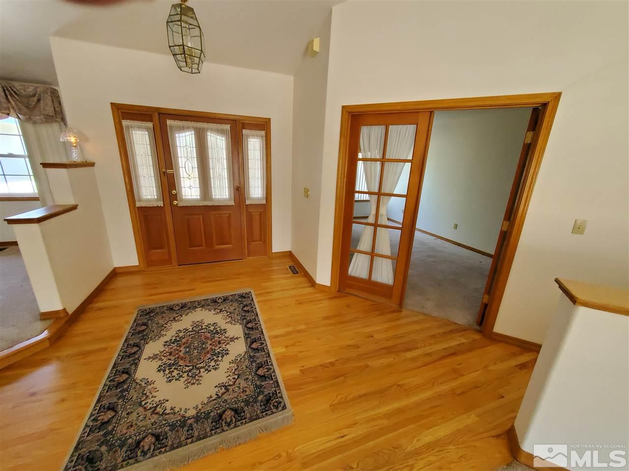 12650 Buckthorn Lane Reno, NV 89511 - Photo 3 of 20 a bedroom with a bed and wooden floor