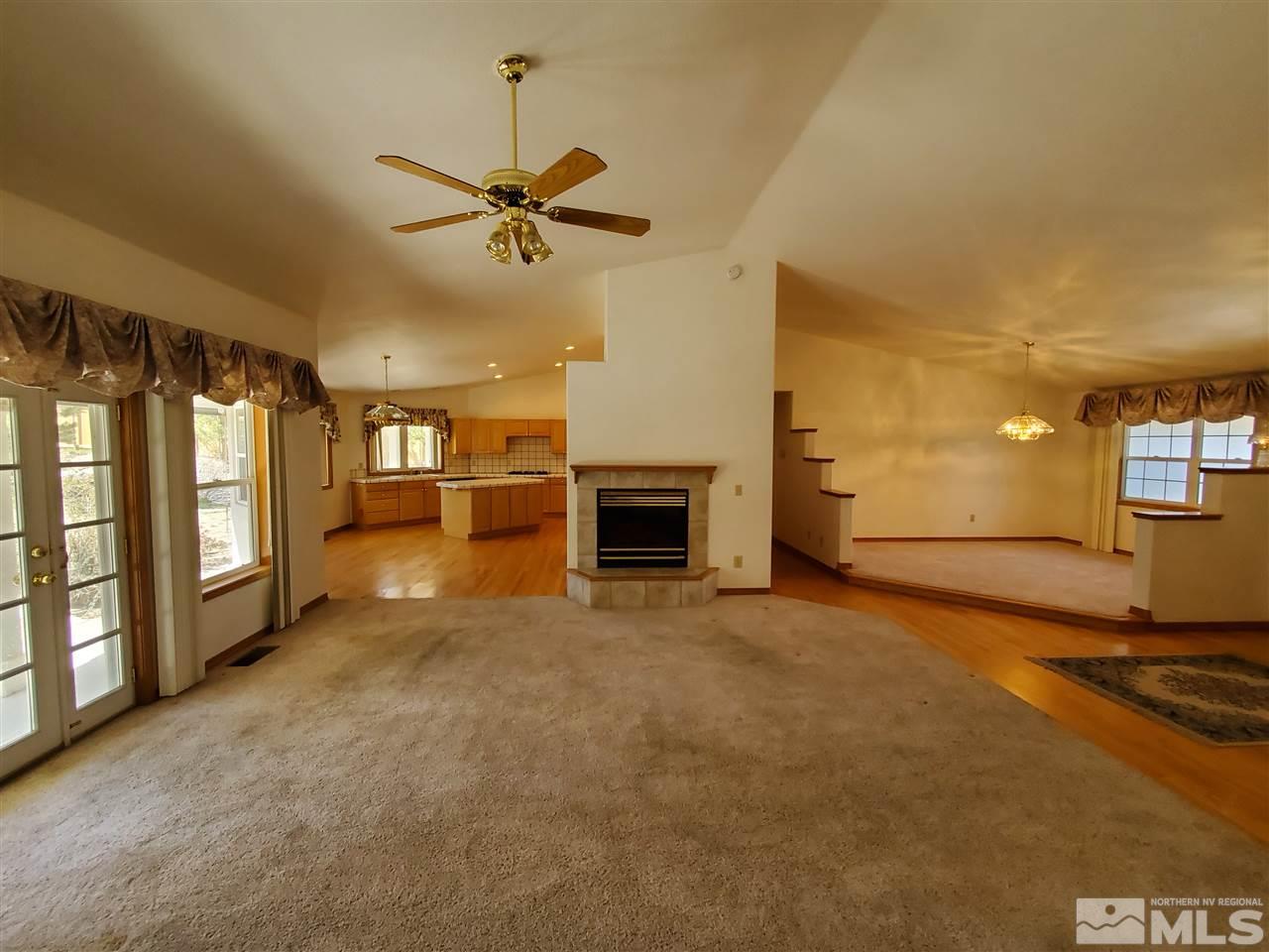 12650 Buckthorn Lane Reno, NV 89511 - Photo 6 of 20 a view of an empty room with a fireplace and a window