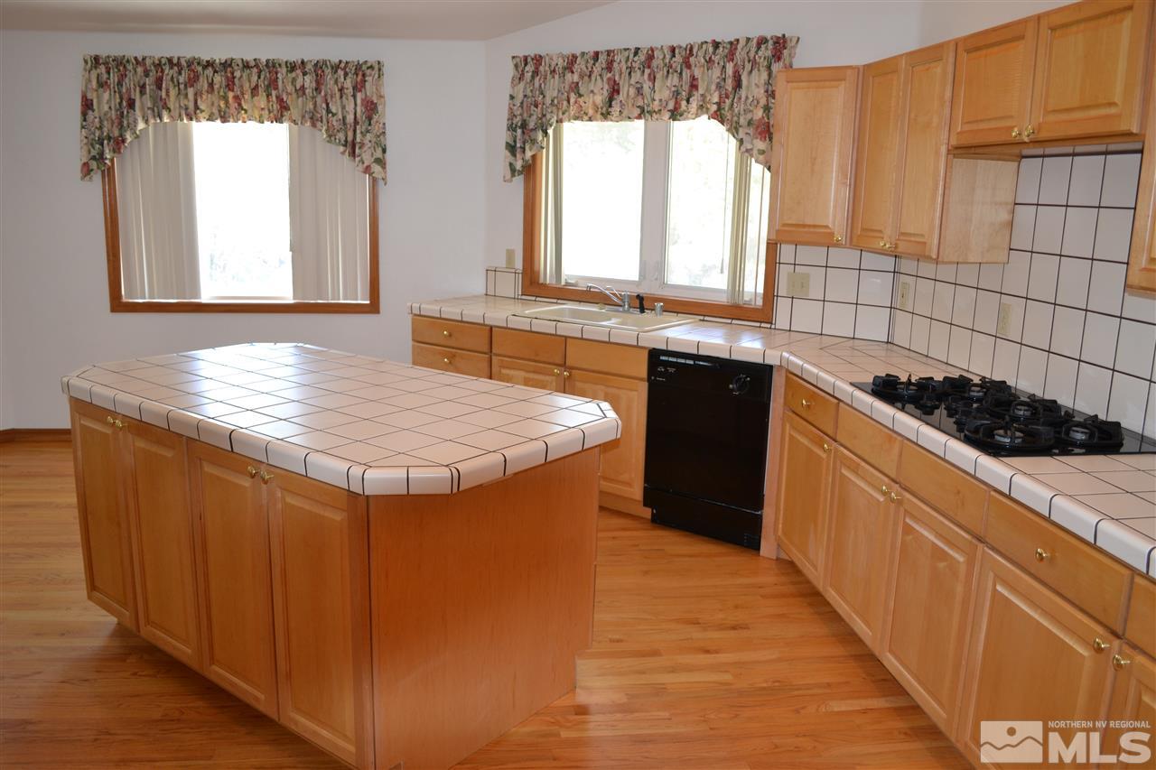 12650 Buckthorn Lane Reno, NV 89511 - Photo 8 of 20 a kitchen with granite countertop a stove and a sink