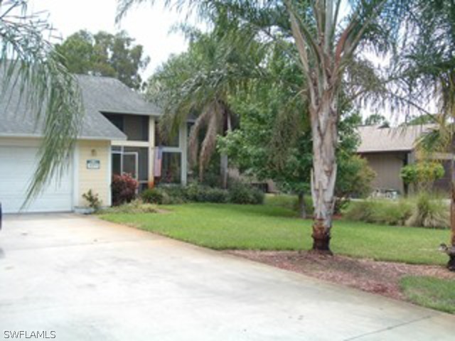 18293 Lee Road Fort Myers, FL 33967 - Photo 1 of 12 a front view of house with yard and green space