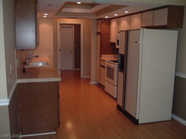 18293 Lee Road Fort Myers, FL 33967 - Photo 3 of 12 a kitchen with stainless steel appliances a refrigerator and a stove