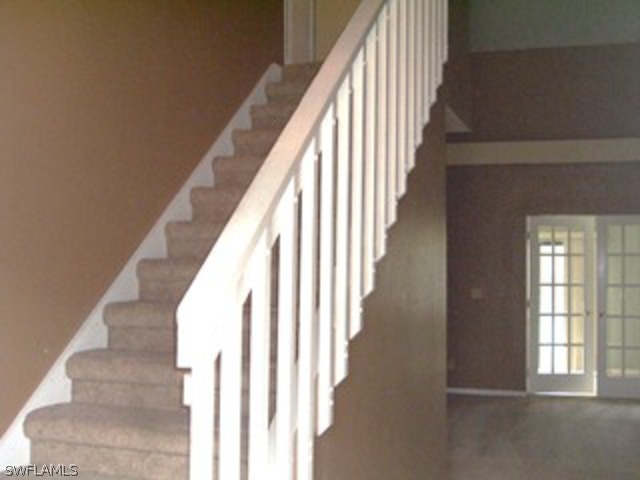 18293 Lee Road Fort Myers, FL 33967 - Photo 8 of 12 a view of staircase with lots of frames on wall and a large window