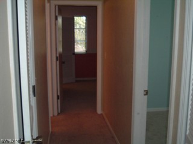 18293 Lee Road Fort Myers, FL 33967 - Photo 9 of 12 a view of a livingroom from a hallway