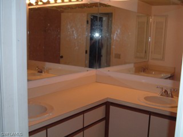 18293 Lee Road Fort Myers, FL 33967 - Photo 10 of 12 a bathroom with a sink and a mirror