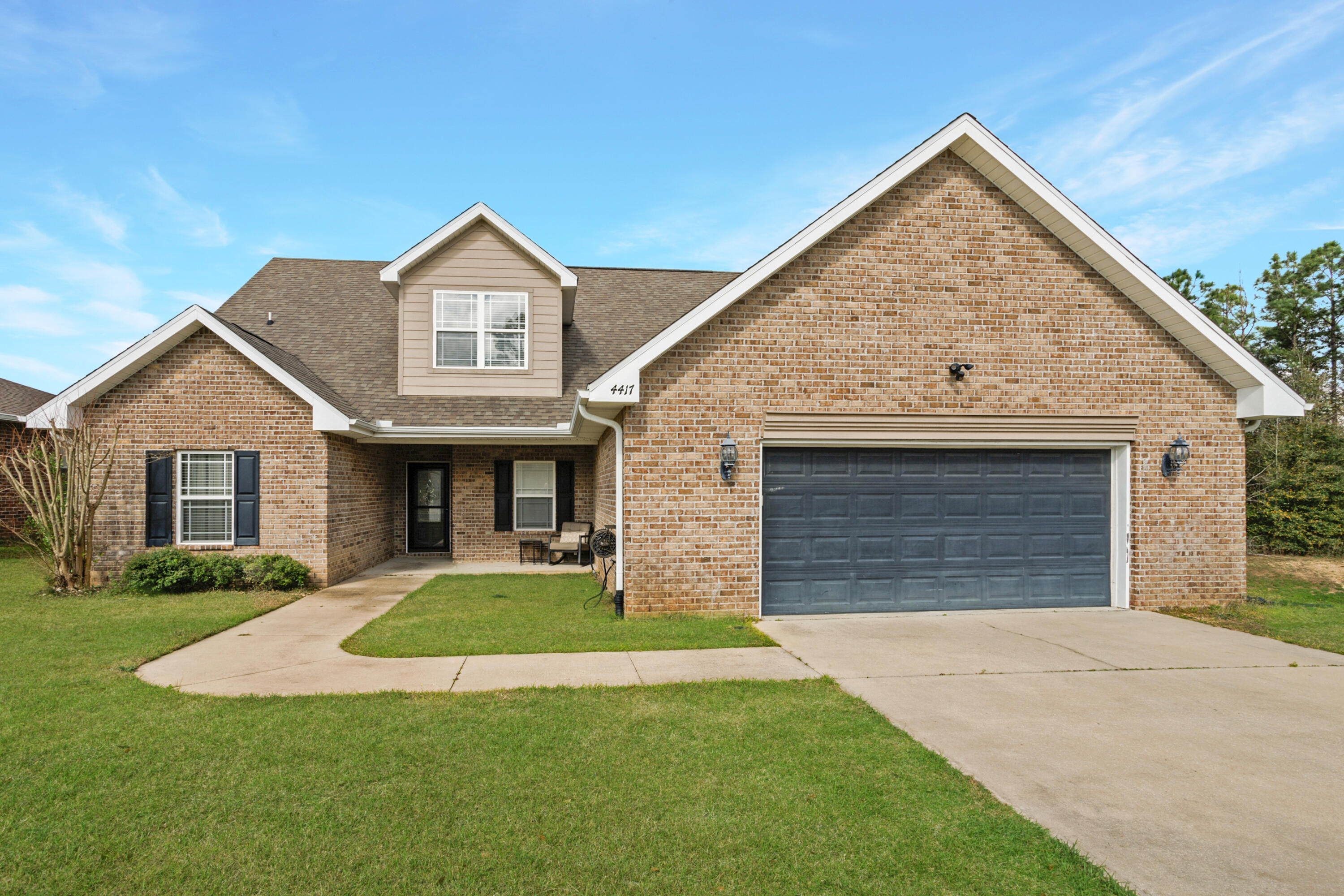 4417 Mirada Way Crestview, FL 32539 - Photo 1 of 37 a front view of a house with a yard and garage