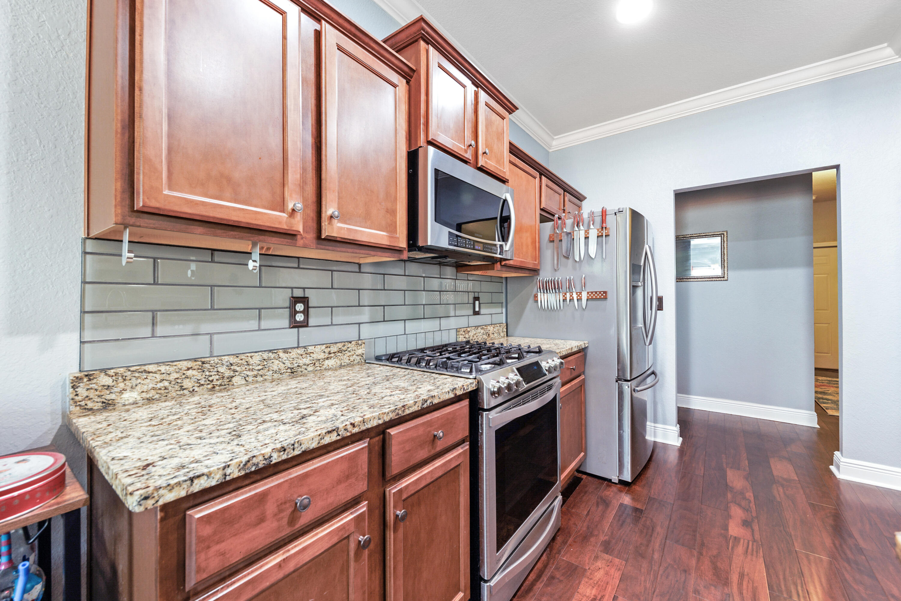 4417 Mirada Way Crestview, FL 32539 - Photo 12 of 37 a kitchen with stainless steel appliances granite countertop a stove and a wooden cabinets