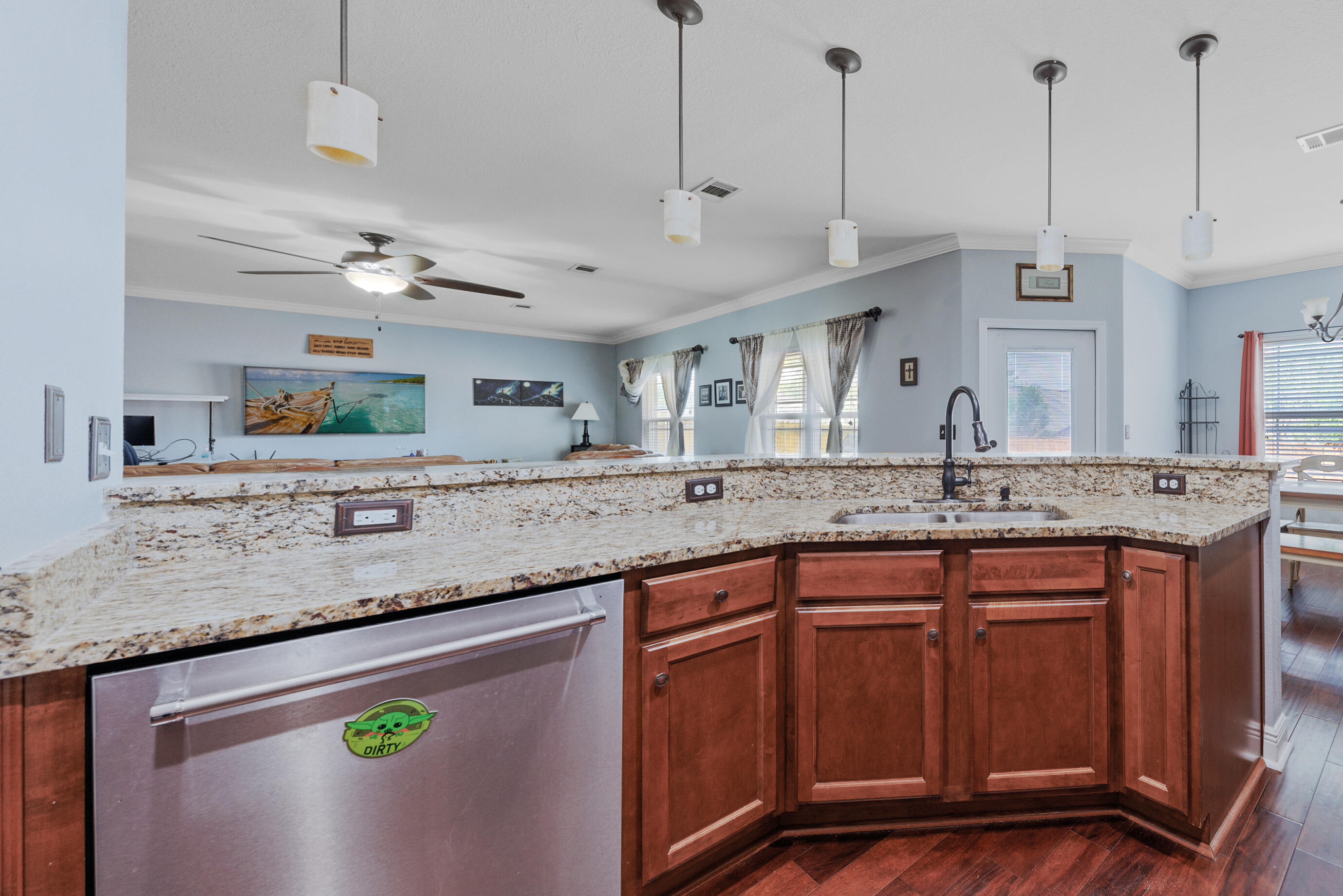 4417 Mirada Way Crestview, FL 32539 - Photo 13 of 37 a kitchen with stainless steel appliances granite countertop a sink a stove and a wooden floors