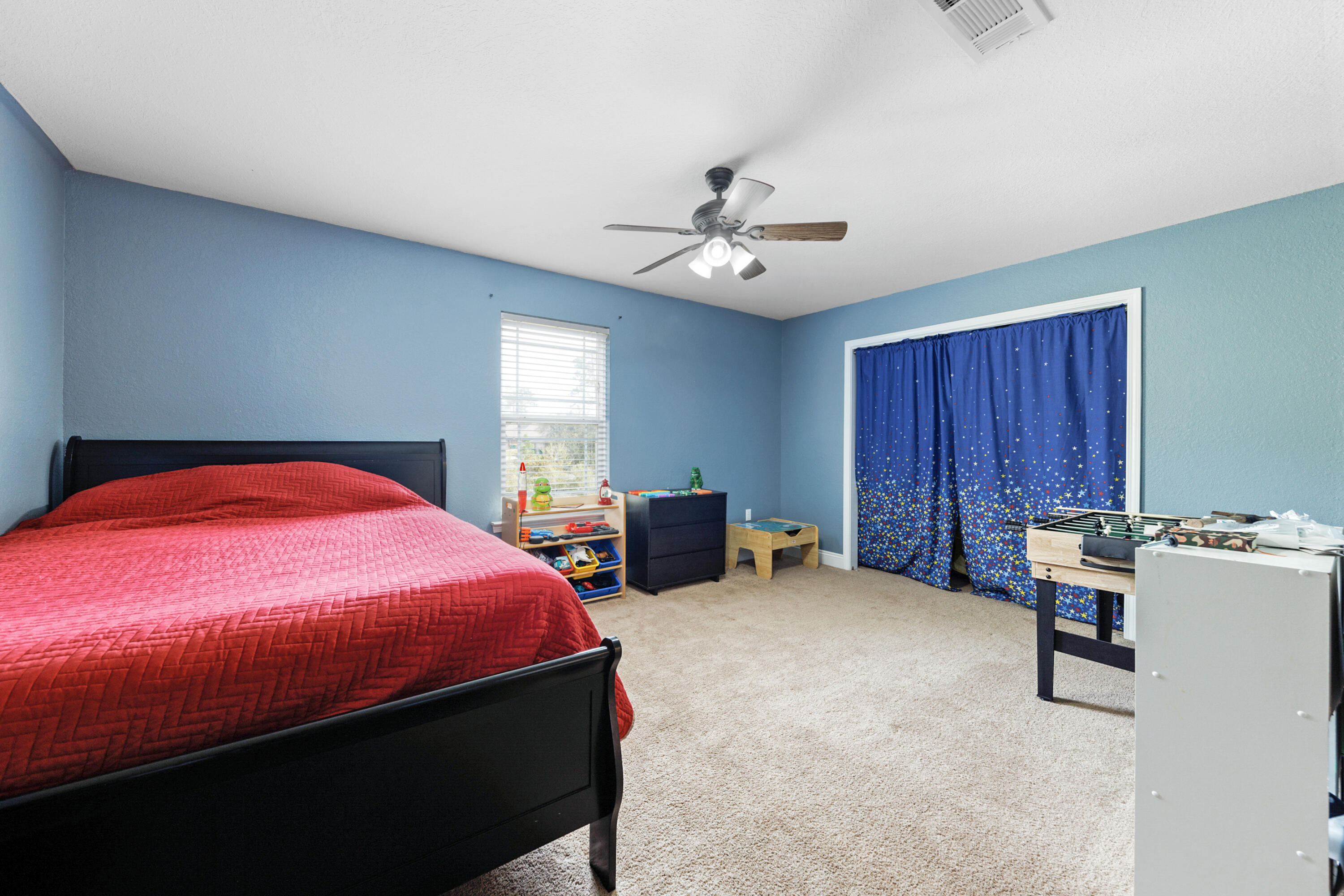 4417 Mirada Way Crestview, FL 32539 - Photo 33 of 37 a bedroom with a bed and a chandelier