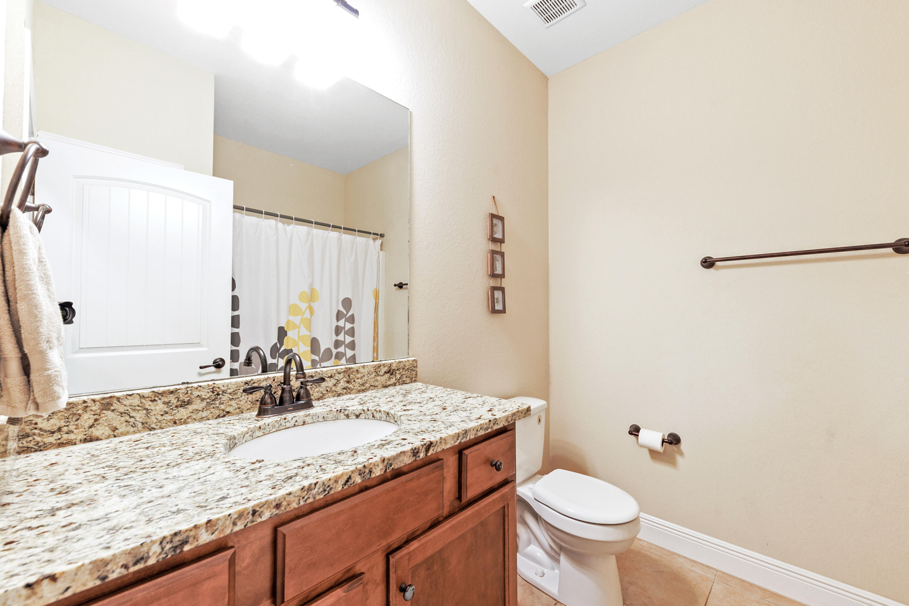 4417 Mirada Way Crestview, FL 32539 - Photo 35 of 37 a bathroom with a granite countertop sink toilet and a mirror