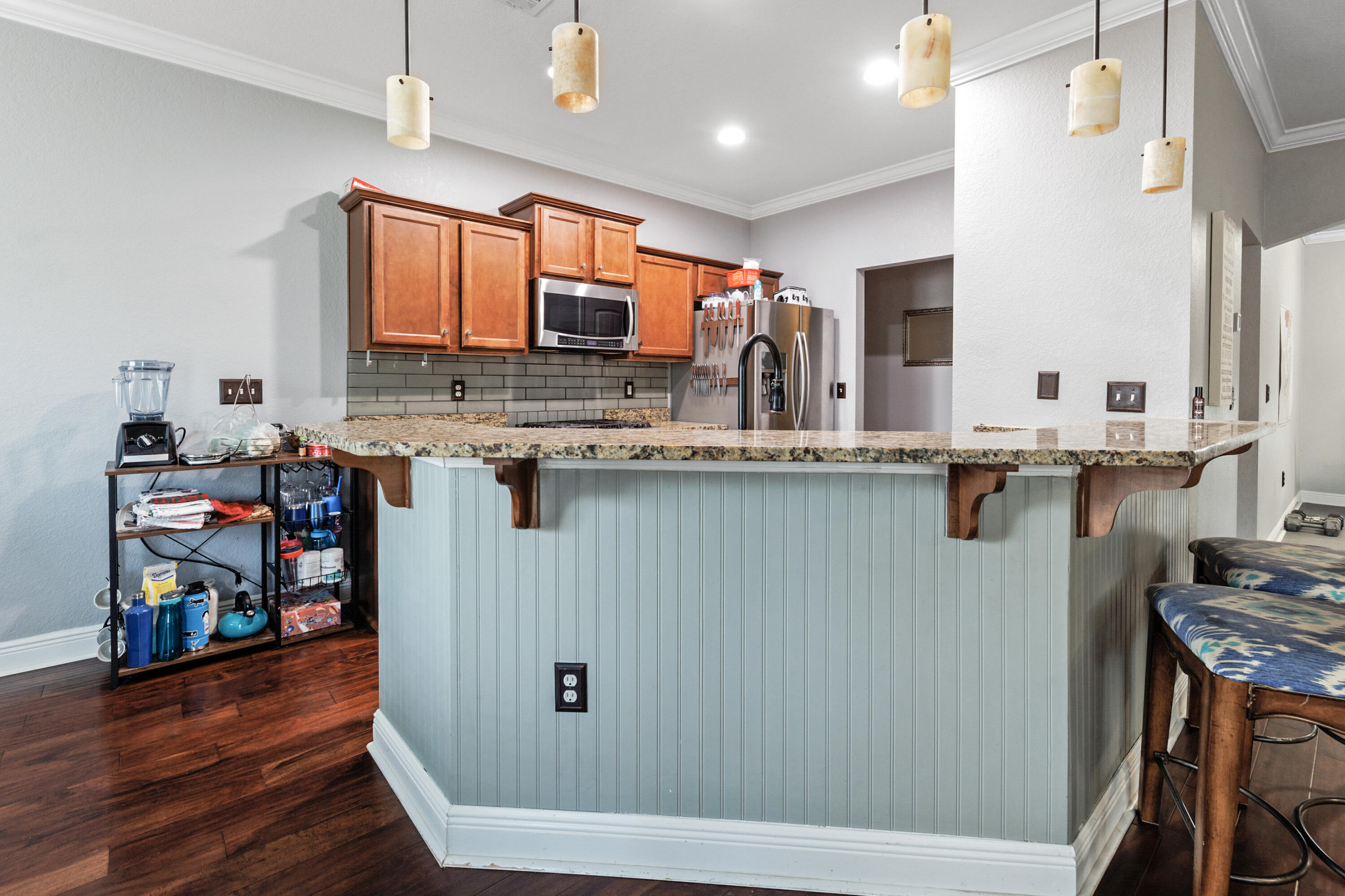 4417 Mirada Way Crestview, FL 32539 - Photo 9 of 37 a kitchen with stainless steel appliances granite countertop a sink stove and wooden floor
