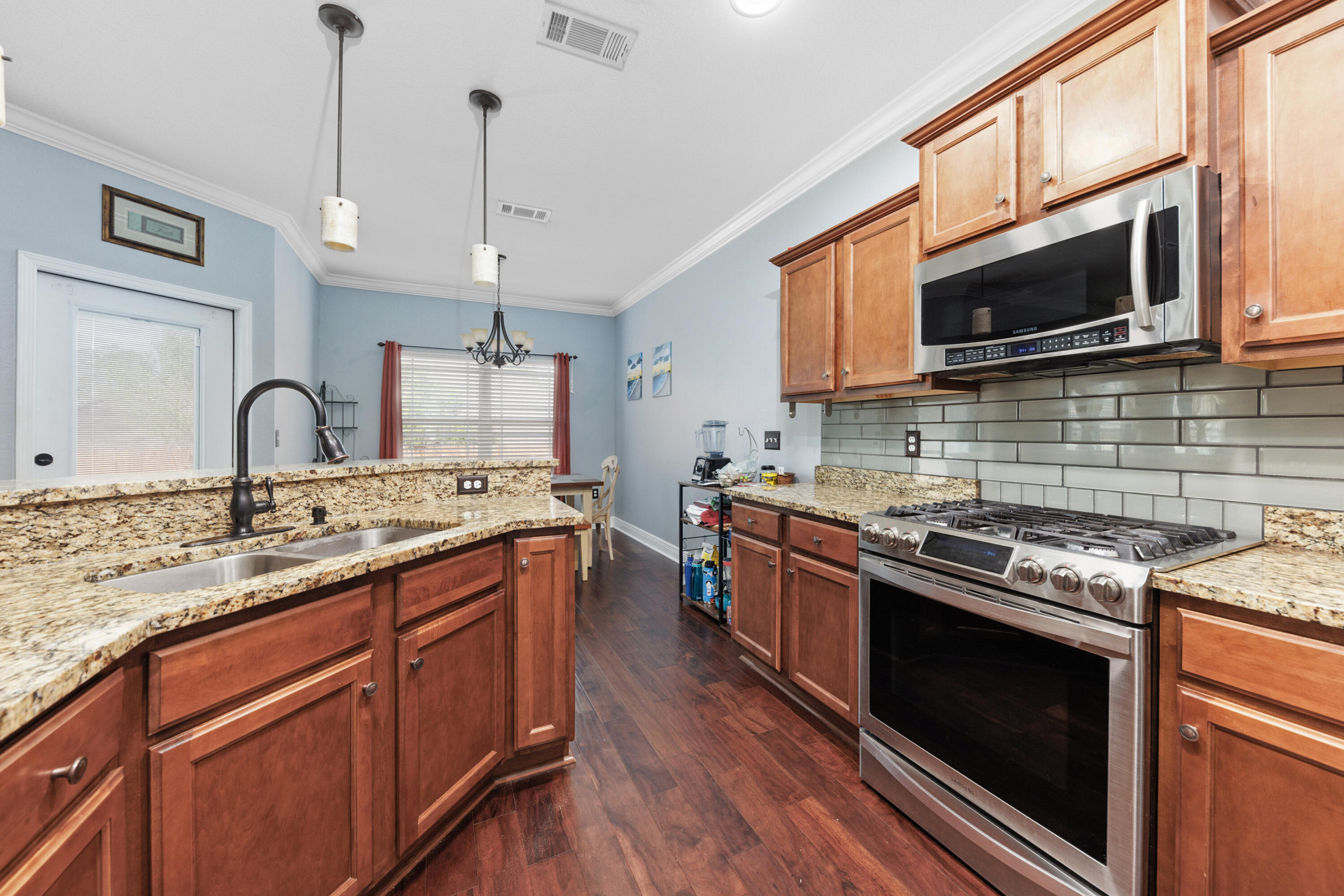 4417 Mirada Way Crestview, FL 32539 - Photo 10 of 37 a kitchen with stainless steel appliances granite countertop a stove microwave and sink