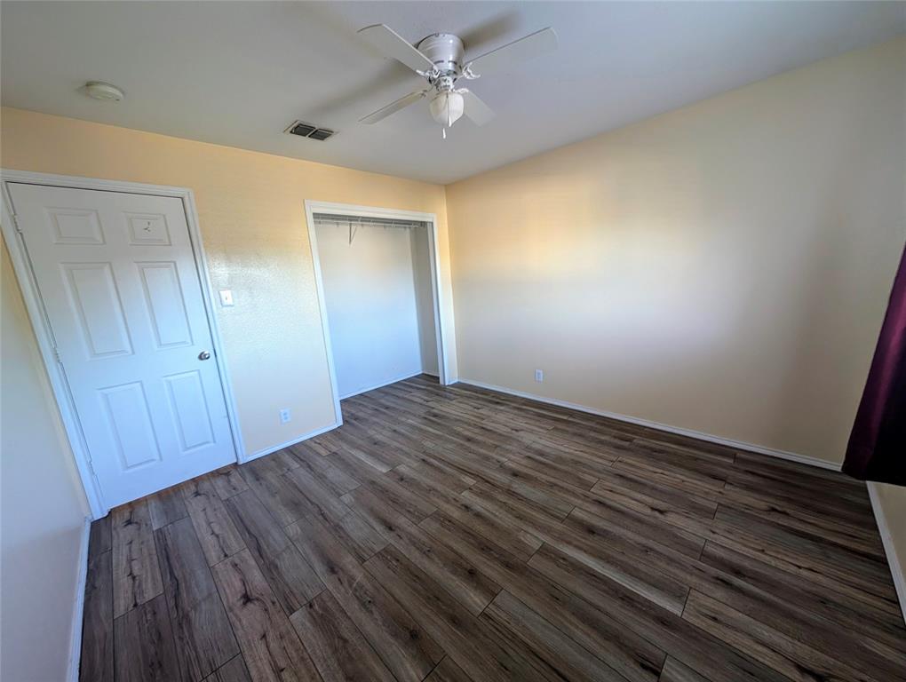 10811 Rindle Ranch San Antonio, TX 78249 - Photo 15 of 18 an empty room with wooden floor and fan