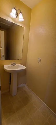 a bathroom with a sink and mirror