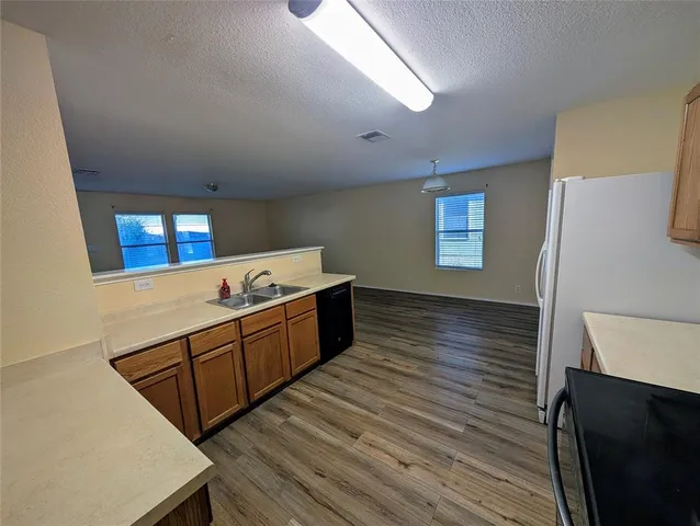 a room with wooden floors and ceiling fan