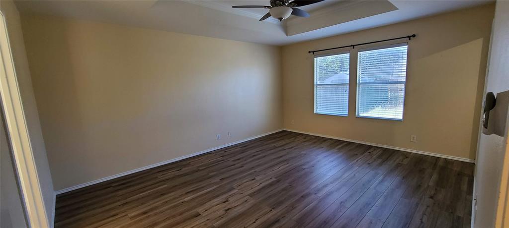 10811 Rindle Ranch San Antonio, TX 78249 - Photo 7 of 18 a view of an empty room with a window and wooden floor
