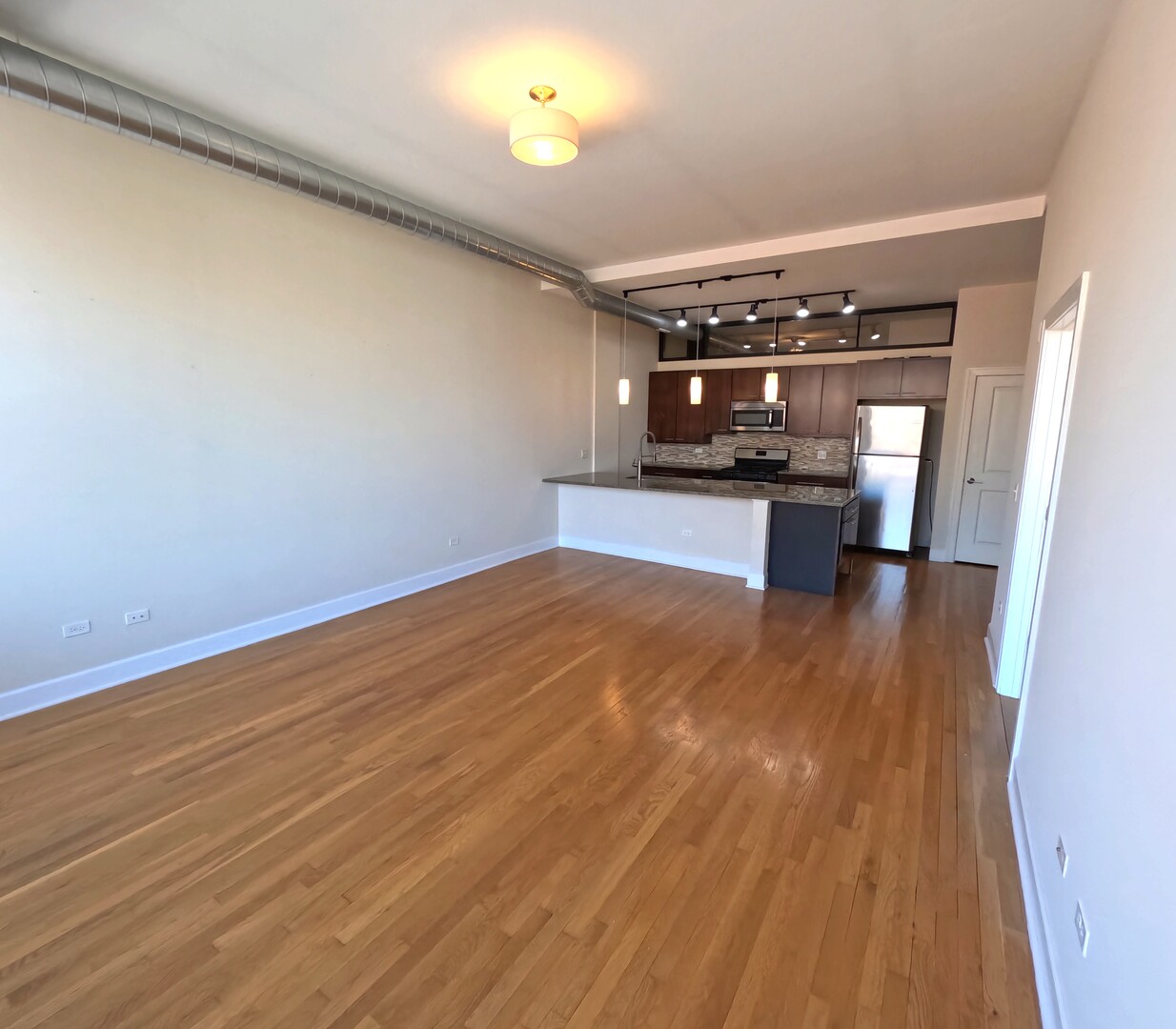 2778 North Milwaukee Avenue, Unit 308 Chicago, IL 60647 - Photo 13 of 18 a view of kitchen with wooden floor
