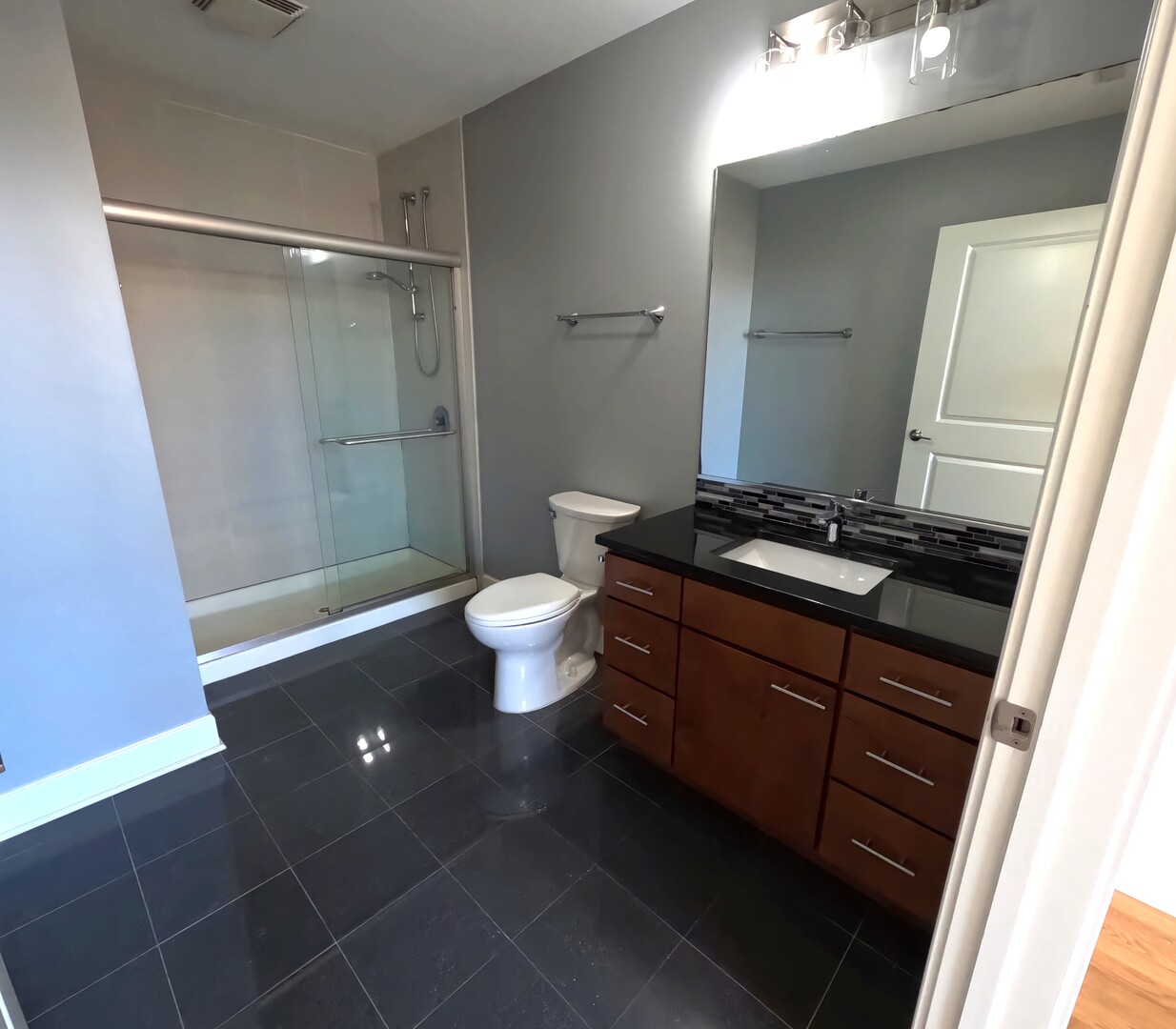 2778 North Milwaukee Avenue, Unit 308 Chicago, IL 60647 - Photo 16 of 18 a bathroom with a granite countertop sink toilet and shower