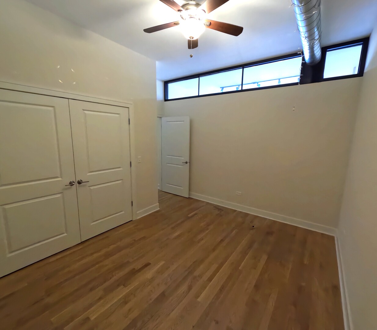 2778 North Milwaukee Avenue, Unit 308 Chicago, IL 60647 - Photo 5 of 18 en empty room with wooden floor