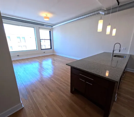 a view of a kitchen with a sink and a window