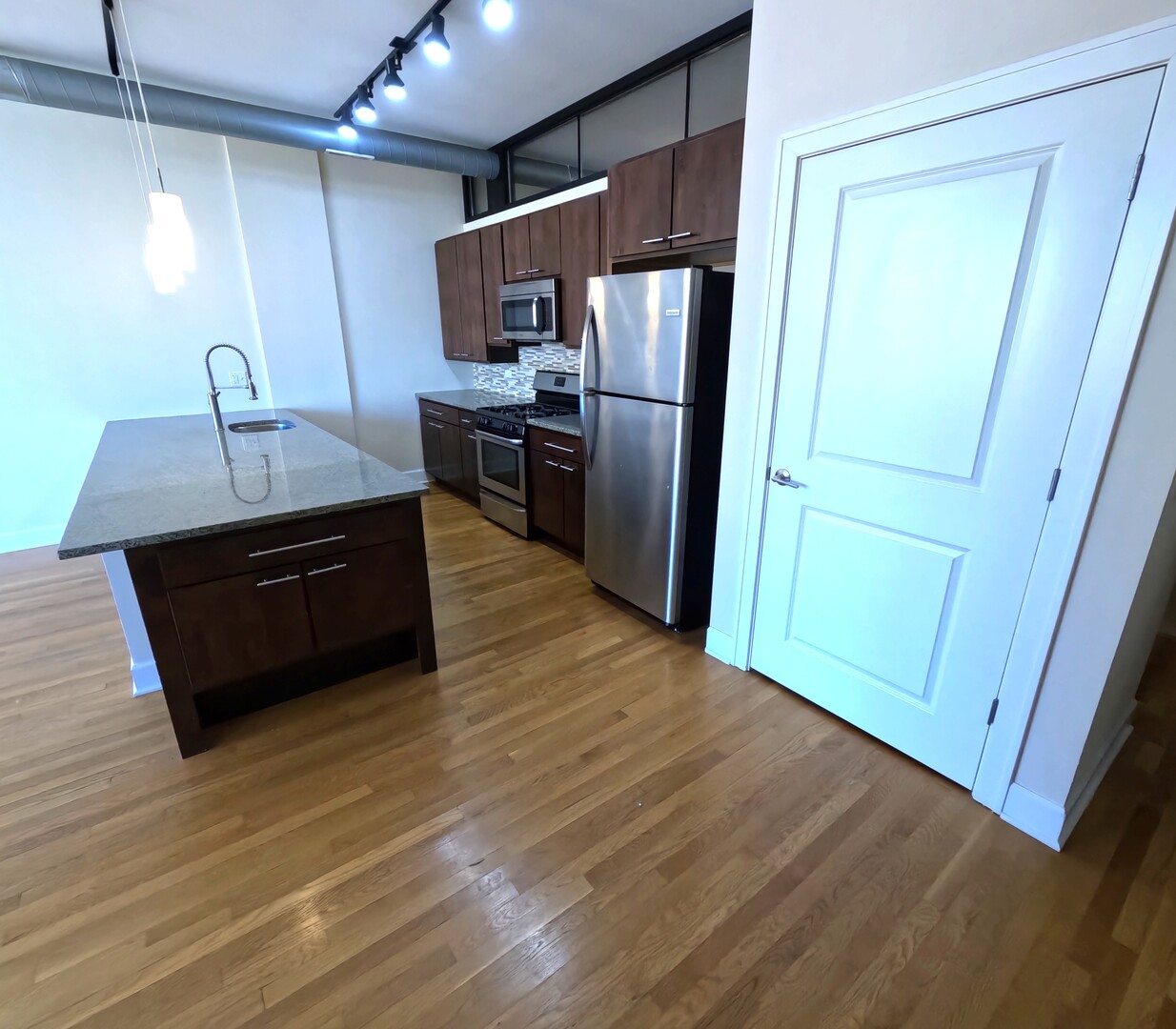 2778 North Milwaukee Avenue, Unit 308 Chicago, IL 60647 - Photo 8 of 18 a kitchen with stainless steel appliances a refrigerator and a sink