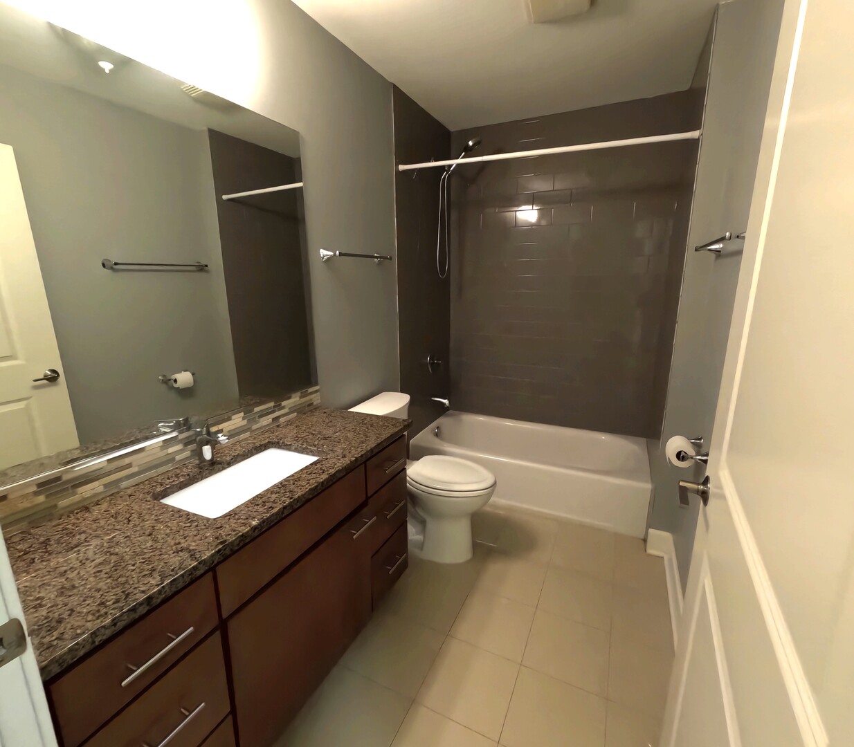 2778 North Milwaukee Avenue, Unit 308 Chicago, IL 60647 - Photo 9 of 18 a bathroom with a granite countertop sink toilet and shower