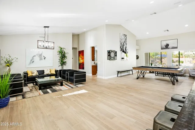 a living room with furniture and wooden floor