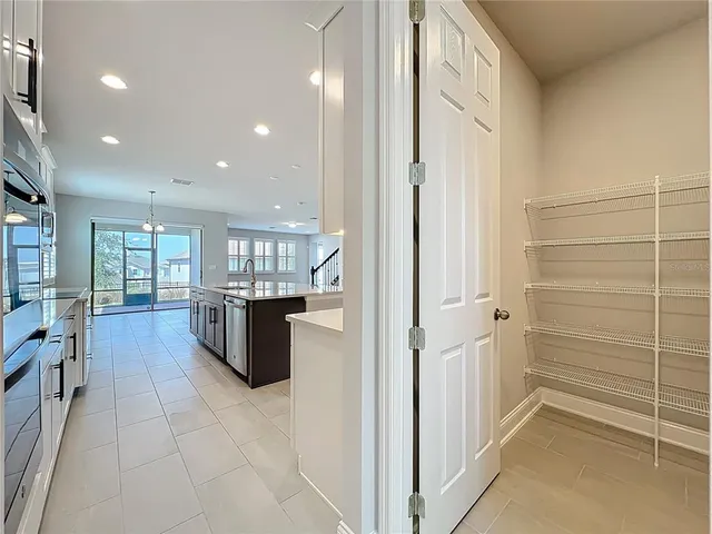 a large kitchen with stainless steel appliances lots of counter top space