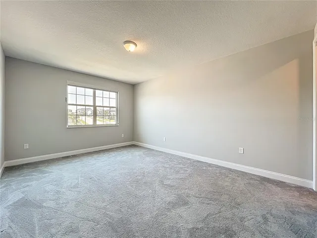 a spacious en suite bathroom with a tub double sink and mirror