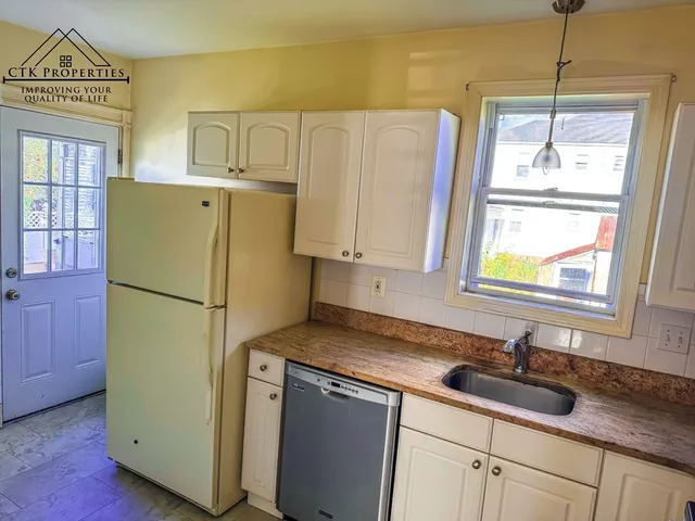 a white refrigerator freezer sitting inside of a kitchen