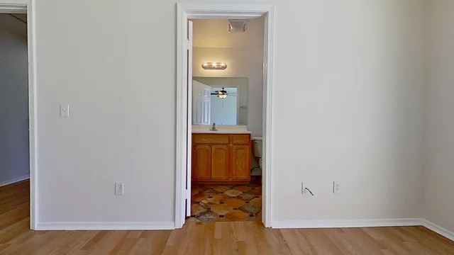a view of a hallway with wooden floor