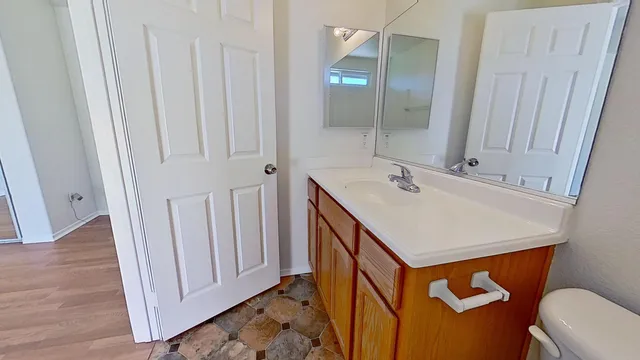 a bathroom with a sink a toilet a mirror and shower
