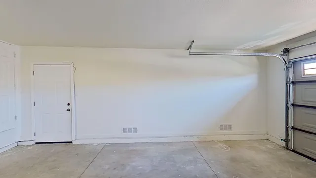 a view of an empty room with a white cabinet