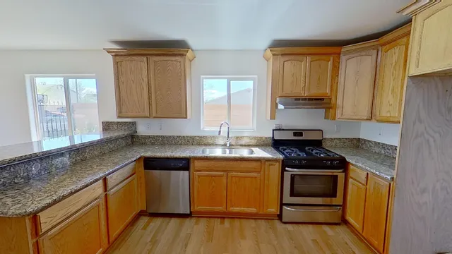 a kitchen with a sink stove and cabinets