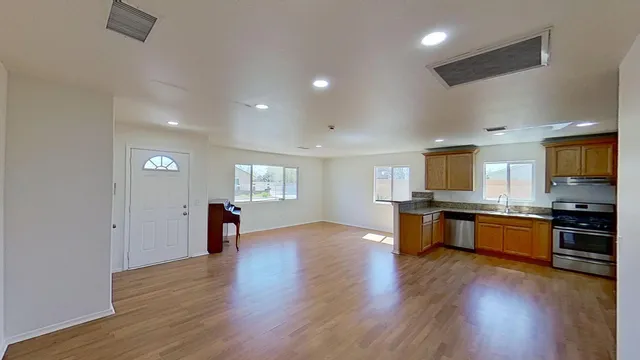 a view of kitchen with sink and wooden floor