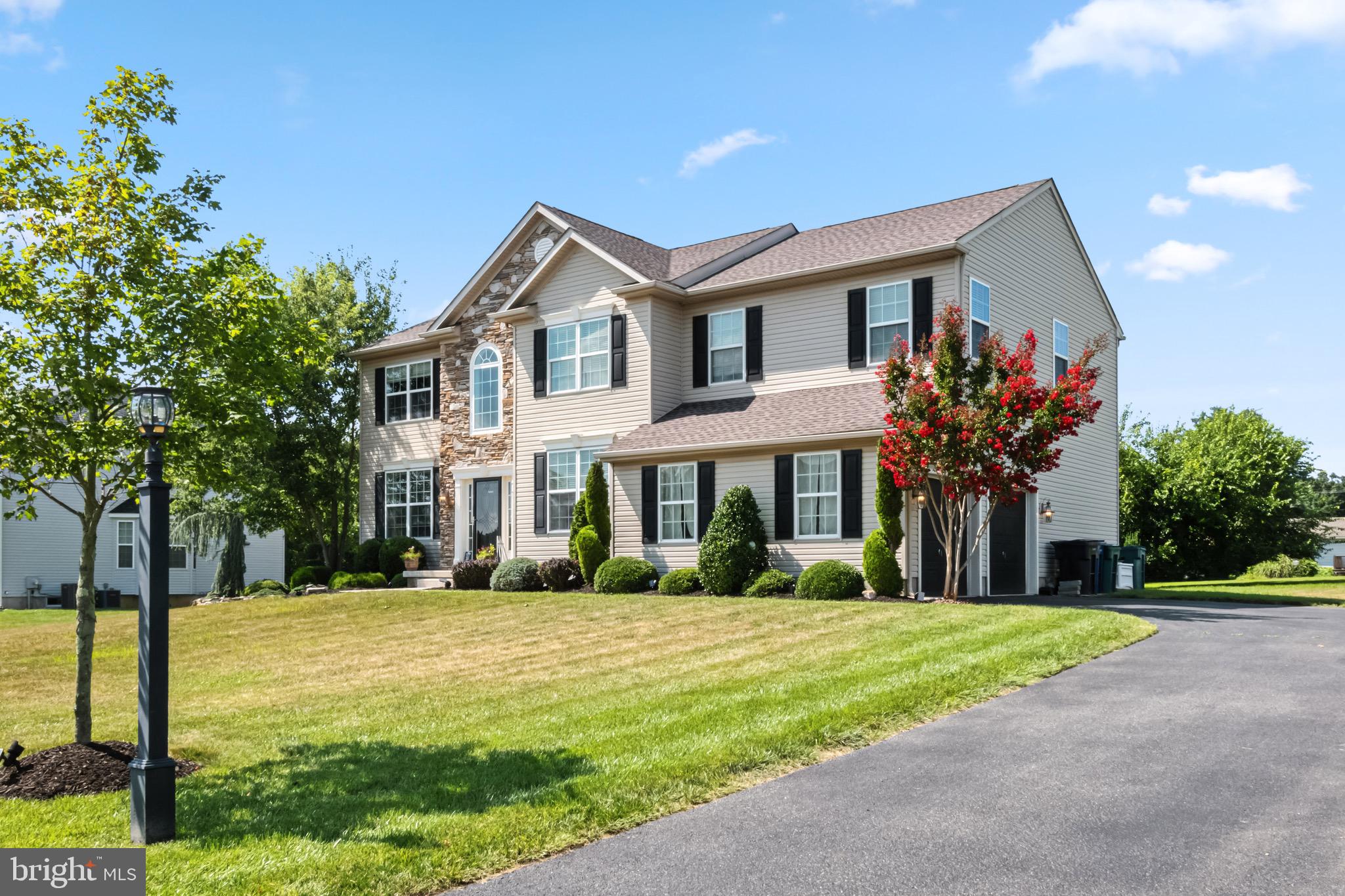 a front view of house with yard and green space