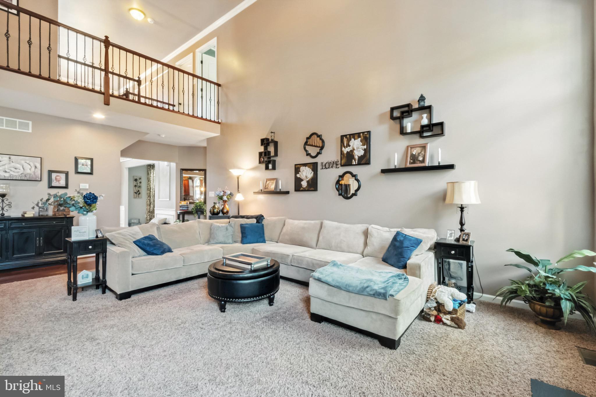 52 Forage Drive Mickleton, NJ 08056 - Photo 15 of 41 a living room with furniture a rug and a chandelier
