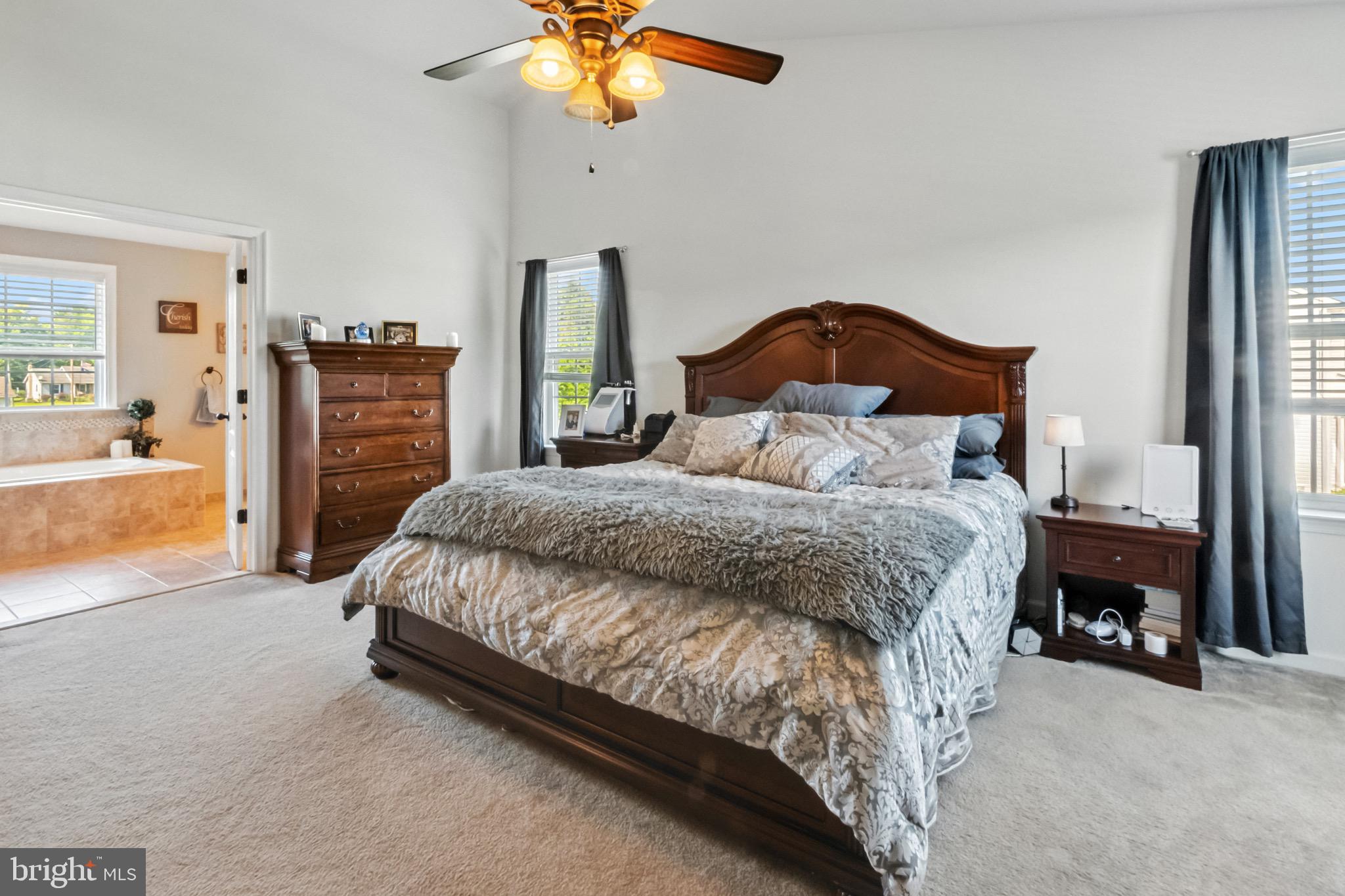 52 Forage Drive Mickleton, NJ 08056 - Photo 26 of 41 a bedroom with a bed and a chandelier