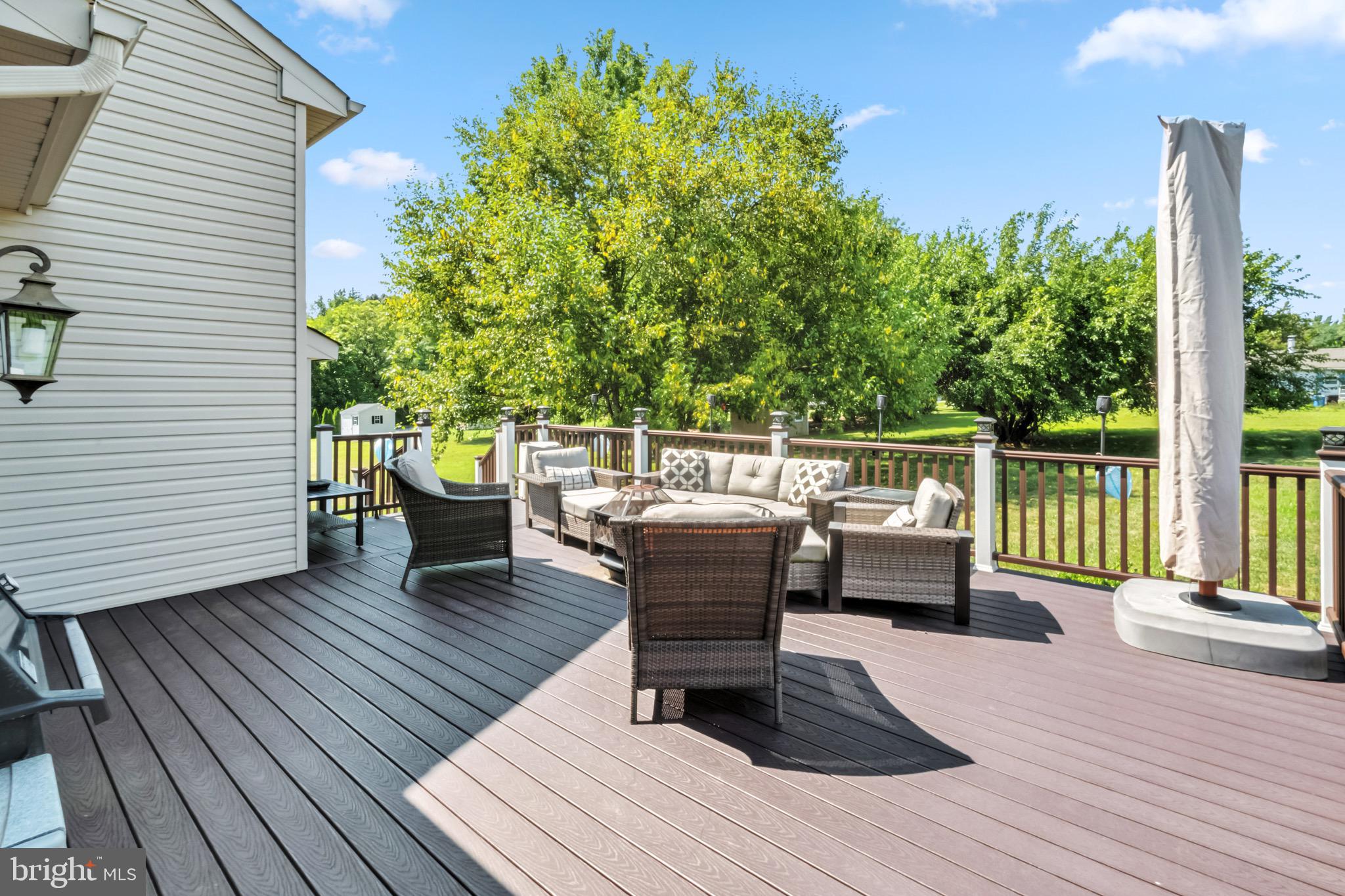 52 Forage Drive Mickleton, NJ 08056 - Photo 8 of 41 a view of a deck with table and chairs and wooden floor