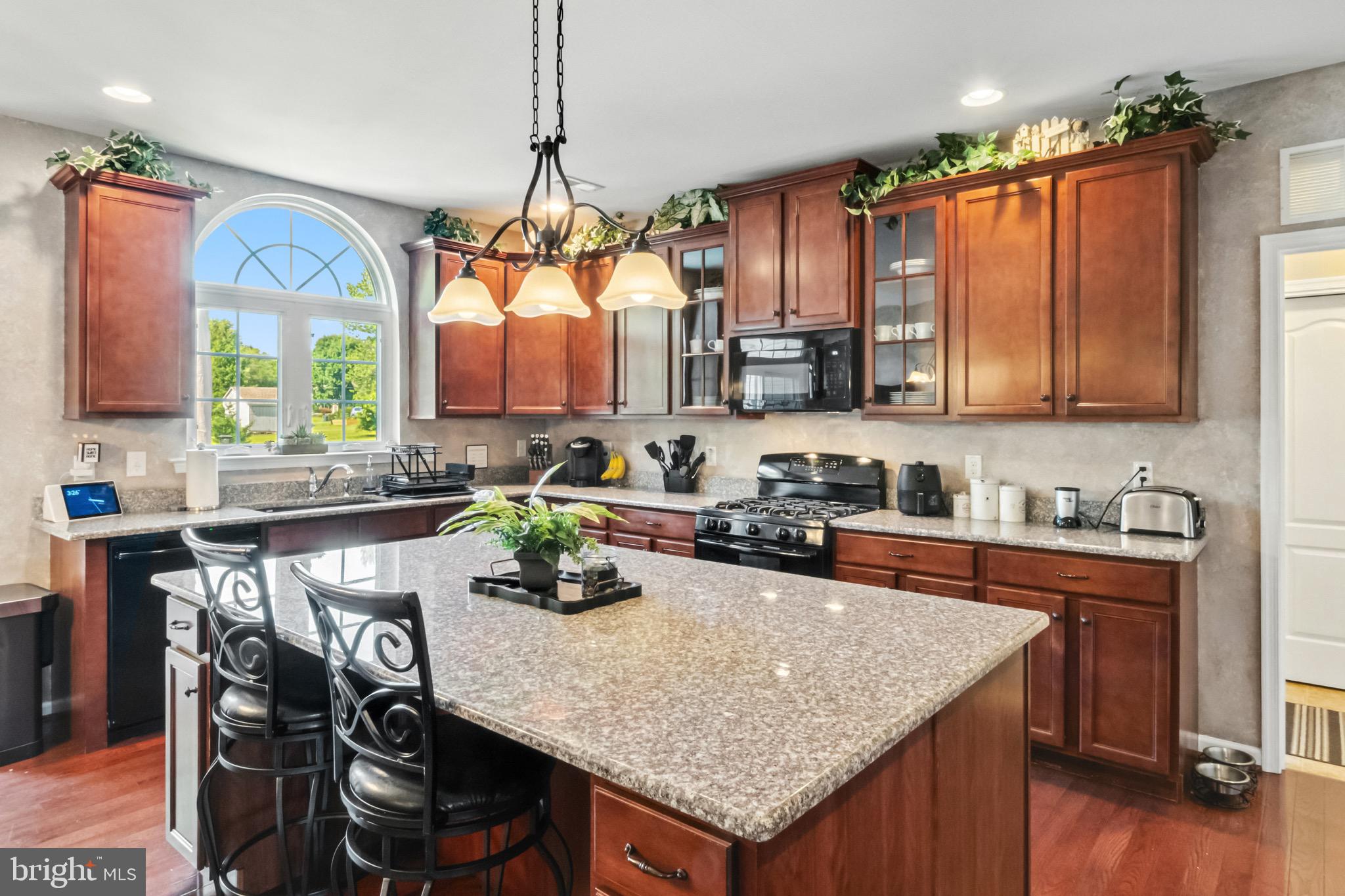 52 Forage Drive Mickleton, NJ 08056 - Photo 10 of 41 a kitchen with a stove a sink a refrigerator and wooden cabinets