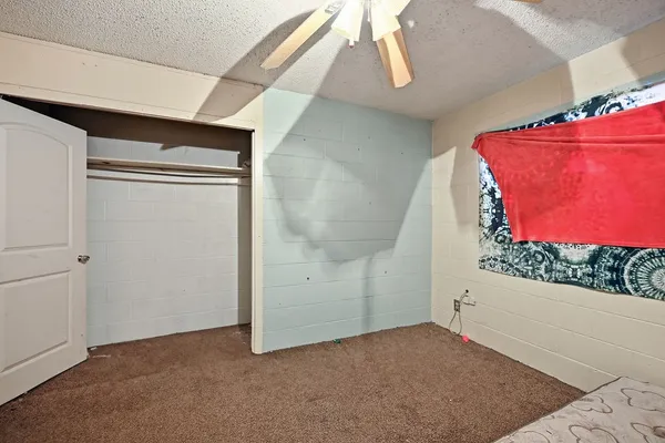 a room with a baby bed and a dresser
