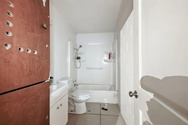 a bathroom with a toilet a sink and mirror