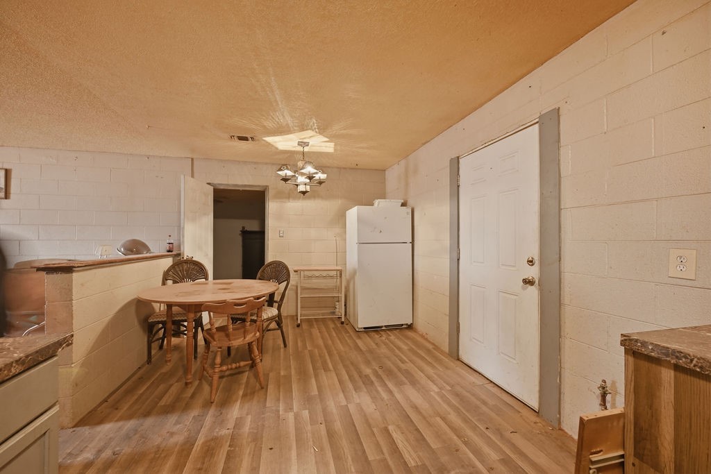 508 South Kenneth Avenue Monahans, TX 79756 - Photo 32 of 39 a view of a dining room with furniture and wooden floor