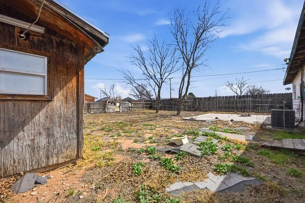 a view of a yard with a large tree