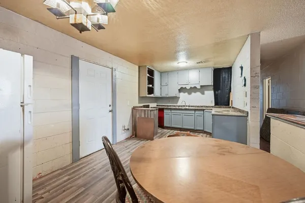 a kitchen with granite countertop a sink stainless steel appliances and cabinets