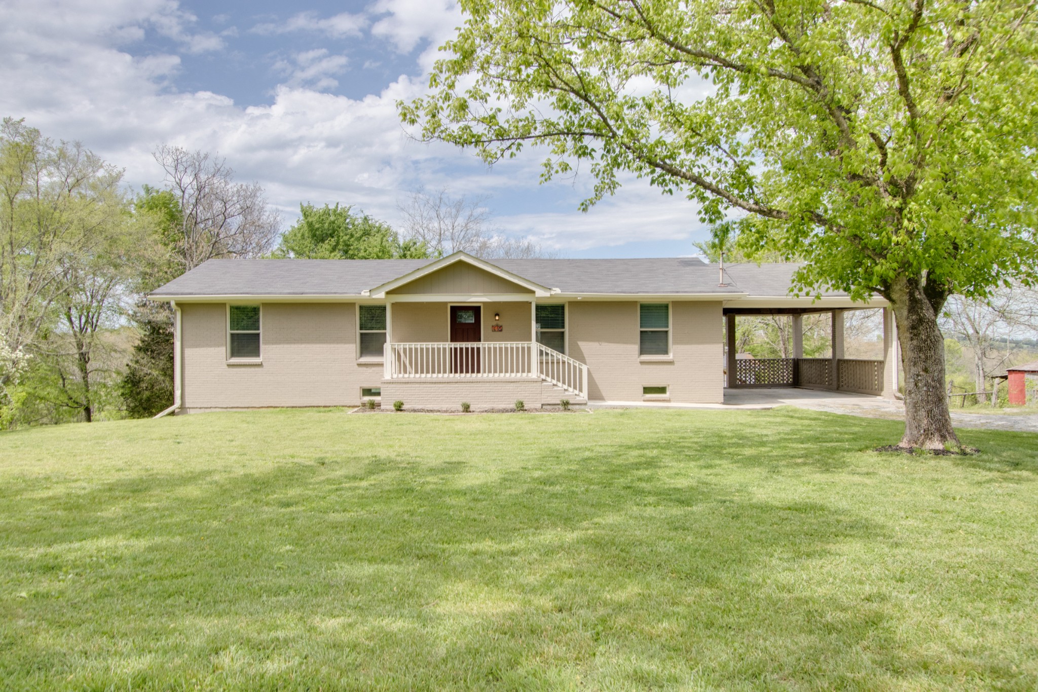 445 Tracy Road Watertown, TN 37184 - Photo 1 of 49 a front view of a house with a garden
